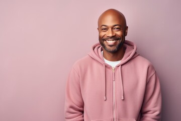 Obraz premium Portrait of a satisfied afro-american man in his 40s wearing a zip-up fleece hoodie isolated on pastel or soft colors background