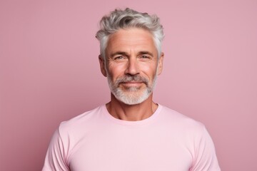 Obraz premium Portrait of a satisfied afro-american man in his 50s showing off a lightweight base layer isolated in pastel or soft colors background