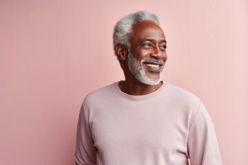 Obraz premium Portrait of a smiling afro-american man in his 60s sporting a long-sleeved thermal undershirt in pastel or soft colors background
