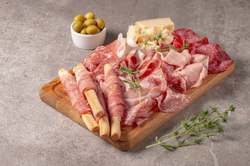 Charcuterie board. Antipasti appetizers of meat platter with salami, prosciutto crudo or jamon and olives.