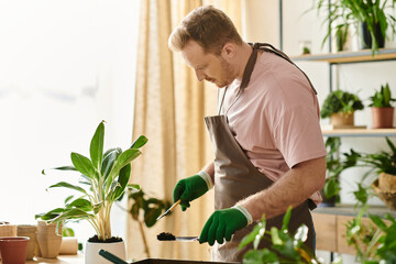 A man in an apron and green gloves expertly prepares a potted plant in a charming plant shop setting.