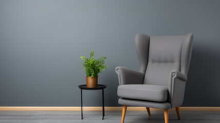 Gray wingback chair, small plant, simple room.
