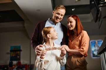 family stand side by side, exuding happiness and togetherness at the cinema.