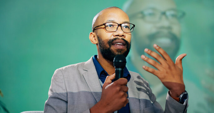 Conference, presentation or speech and public speaking man with microphone on stage for development seminar. Business, black man and workshop with motivational speaker person in corporate auditorium