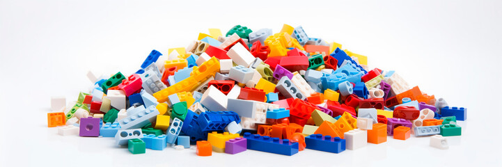 White background, white space in the center of picture. A pile of colorful blocks scattered all over the place. The bricks of different shapes and sizes to show diversity