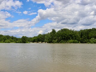 The flowing river in the countryside on a sunny day.