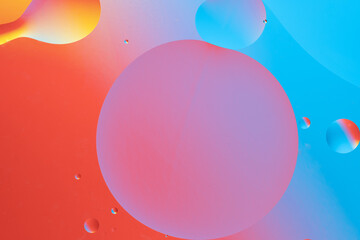 Colorful abstract background with dynamic bubble shapes. Red and blue gradient.