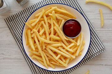 Homemade American French Fries with Ketchup on a Plate, top view.