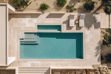 Aerial view of a modern minimalist pool with sun loungers in a villa