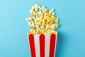 Popcorn box. Red and white striped buckets of salted popcorn on background. Cinema and entertainment concept. Movie night with popcorn. Delicious appetizer, snack. Place for text.
