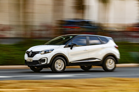White Renault Kaptur in movement, Crossover in city street, High Resolution Panning Shot