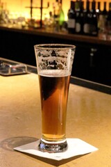 Drinking a cold beer at a bar