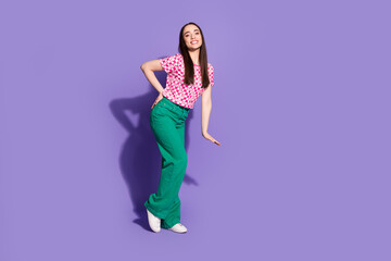 Full size photo of pretty young woman posing empty space wear checkered t-shirt isolated on purple color background