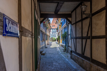 Fototapeta premium Passage and half-timbered houses in the Alley called Schuhhof (shoemakers court) in the old city of Quedlinburg, Saxony-Anhalt, Germany