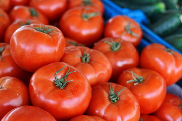 Tomatoes lying on a pile on top of each other, tomato texture. Selective focus.