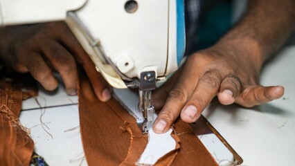 Obraz premium Garment worker swing clothes with machine and hand closeup shot 