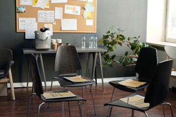 Group of chairs making circle prepared for attendants of post traumatic syndrome support group in spacious studio or modern office
