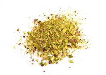 Scattered pistachio nut pieces isolated. Break chopped pistachios pile, fried baked diced pistache on white background 