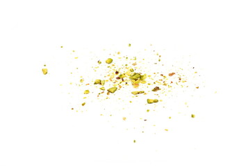 Scattered pistachio nut pieces isolated. Break chopped pistachios pile, fried baked diced pistache on white background 