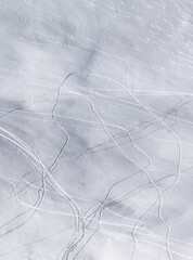 Off piste snowy slope with traces of skis and snowboards