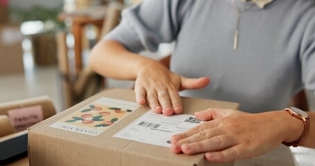 Woman, hands and package label for delivery of e commerce order, shipping information and courier. Female owner, logistics and box with business sticker, stock packaging and process of distribution