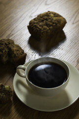 Cup of Steaming Coffee Next to Breakfast Pastries