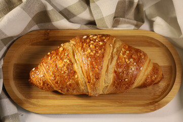 Homemade fresh croissant. Fragrant pastries on a wooden tray. Ecological concept. View from above
