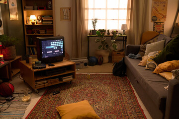 Retro 8bit gaming setup in cozy living room with vintage TV, shelves with stuff, and scattered pillows on sofa and old-fashioned carpets on floor creating nostalgic atmosphere