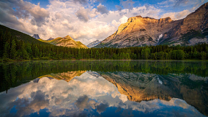 Mountains reflecting in calm lake at sunset