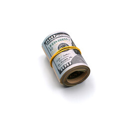 A roll of American hundred dollar bills tied with an elastic band isolated on a white background. 