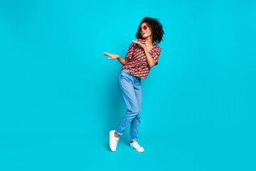Photo of positive cheerful girl look copyspace dancing party isolated cyan color background