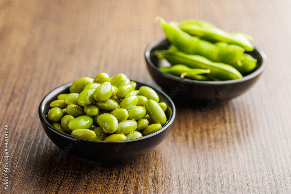 Canvas Prints edamame soy beans in bowl on wooden table.