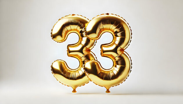 Golden Foil Balloons Forming the Number 33 on a Light Background