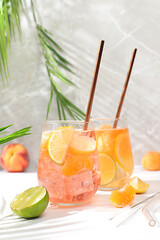 Ice cold homemade lemonade, juice or cocktail with mint, apricots, peaches and citrus fruits, recipe for a refreshing summer drink, detox diet and weight loss concept, menu for restaurant,