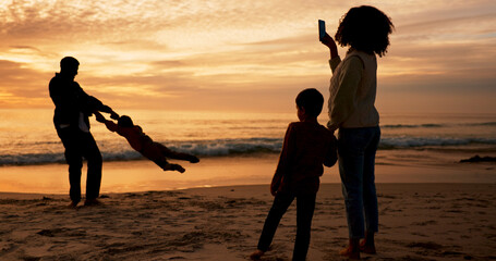 Family, sunset and fun on beach vacation together, people and father swinging child for bonding in...