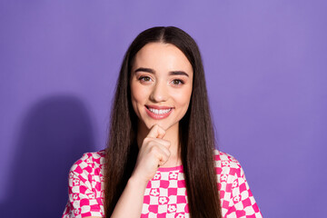 Portrait of nice young woman hand touch chin think wear checkered t-shirt isolated on violet color...