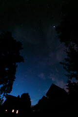 Dark night with stars on blue sky with silhouette