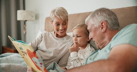 Grandparents, girl and reading book in bed for fairytale, literature and bonding at sleepover....