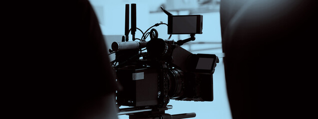 Film director and crew making commercial content advertising in studio. Filmmaker crew team with professional cinema equipment and video camera on the set. Technique of modern filming and advertising.