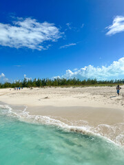 tropical beach and waves against a blue sky 