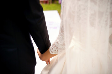 Bride and Groom Holding Hands at Wedding Ceremony