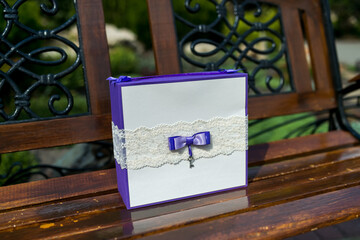 Purple Gift Box on Wooden Bench