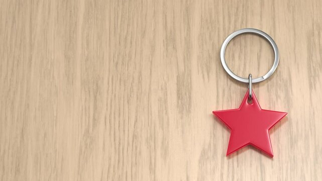 Keyring with a shiny red heart on a wood background
