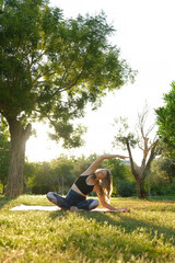 Female Practice Yoga Outdoors. young woman doing yoga position outdoors by a sea on a sunny day. morning meditation