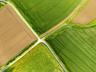 Aerial view of track through farmland. Route on small road through countryside. Background with agricultural fields.
