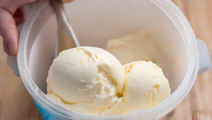 Close up Vanilla ice cream scooped out from container with a spoon, Food concept, Generative AI


