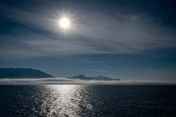 Bright Sun Moody Mountains Dark Water 