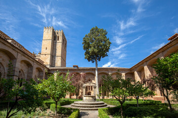 Obraz premium Interior of the medieval landscaped cloister of Sigüenza Cathedral, Guadalajara, Spain, with one of the towers in the background