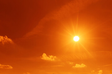 Hot whether concept. Orange sky with bright sun