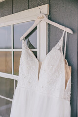 wedding dress hanging on a bride hanger